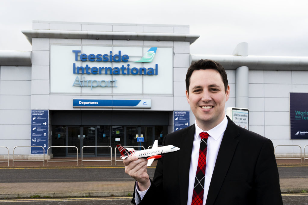 Mayor Ben Houchen outside Teeside Airport with Loganair model