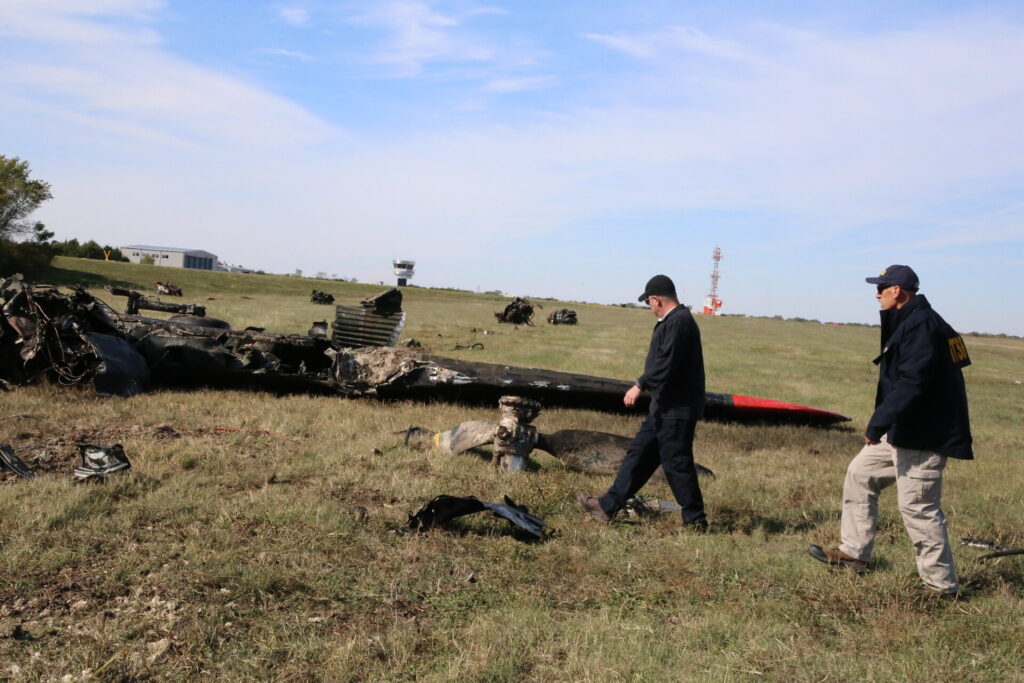 NTSB Member Michael Graham & NTSB Investigator-in-Charge Jason Aguilera walks the accident scene of the Nov. 12, mid-air collision between a Boeing B-17G and a Bell P-63F near Dallas, Texas.