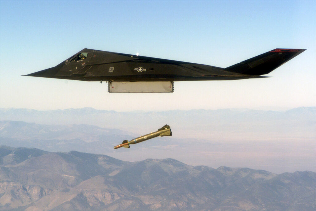 An F-117 Nighthawk engages its target and drops a GBU-28 guided bomb unit during the 'live-fire' weapons testing mission COMBAT HAMMER, at Hill Air Force Base, Utah. (Public Domain)