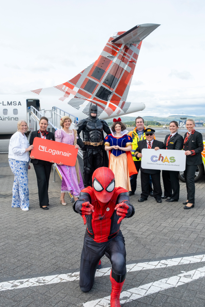 Members of the Loganair and CHAS teams with Spider-Man, Batman, Rapunzel, and Snow White.
